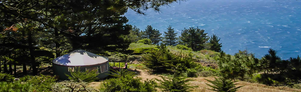 Lush resort with a yurt looking
	out over the ocean